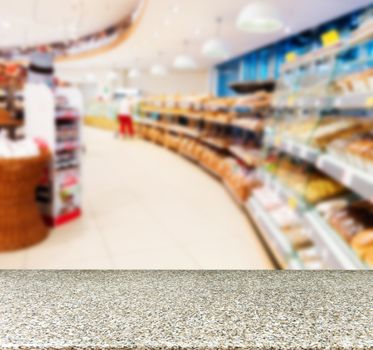 Marble board empty table in front of blurred background. Perspective marble over blur in supermarket - can be used for display or montage your products. Mock up for display of product.