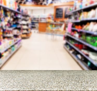 Marble board empty table in front of blurred background. Perspective marble over blur in supermarket - can be used for display or montage your products. Mock up for display of product.