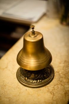 old style bronze bell in a hotel reception