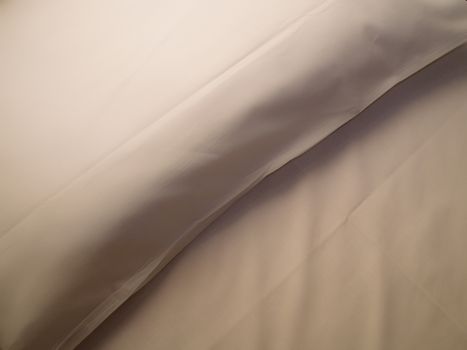 a white pillow with its shadows and whites