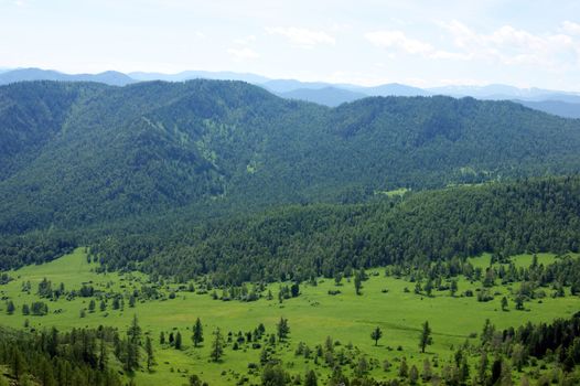 Colorful landscape of the mountains and glade by summer