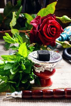 Hookah pipe and hookah filled with tobacco with the scent of mint and roses