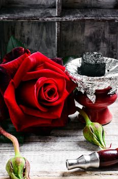 Smoking hookah filled with tobacco with the taste of roses