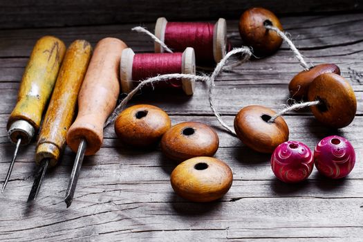 Vintage set awl,wooden beads jewelry laid out on wood