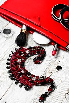 Fashionable ladies handbag with cosmetics and decorations