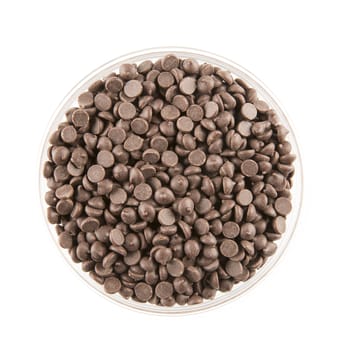 Chocolate chips in a glass bowl, isolated on white and viewed from directly above.