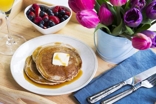 Fresh fruit and pancakes along with tulips for a wonderful brunch.