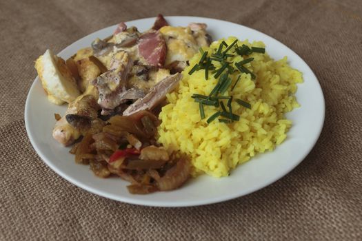 picture taken January 16, 2016 Jablonec nad Nisou, Czech Republic baked chicken with rice and pickles on a white plate light background