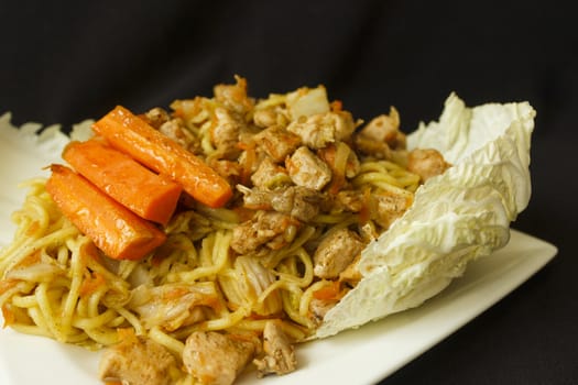 Taken 15. January 2016 Jablonec above Nisou, Czech Republic china noodle chicken meat odds grated carrot, odds cabbage to leaf Chinese cabbage white plate dark background