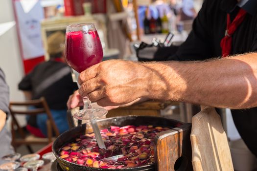 Refreshing sangria with fruits being served on urban street food stall. Urban international kitchen event in Ljubljana, Slovenia, in summertime.