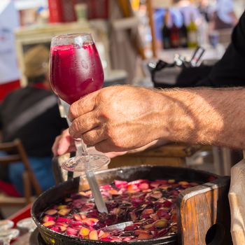 Refreshing sangria with fruits being served on urban street food stall. Urban international kitchen event in Ljubljana, Slovenia, in summertime.