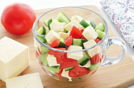 Salad with vegetables and cheese, and ingredients on the cutting Board. Morning light, bokeh.