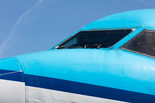 Cockpit close up of blue jet airplane