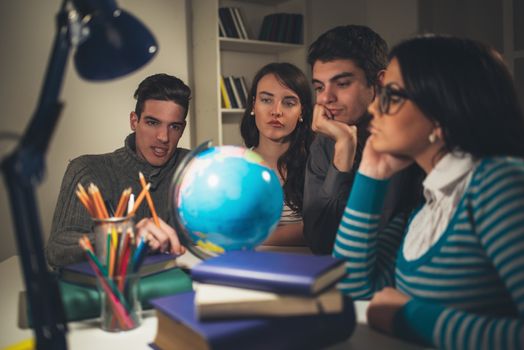 Four beautiful students of Geography learning with globe and thinking. Vintage concept.