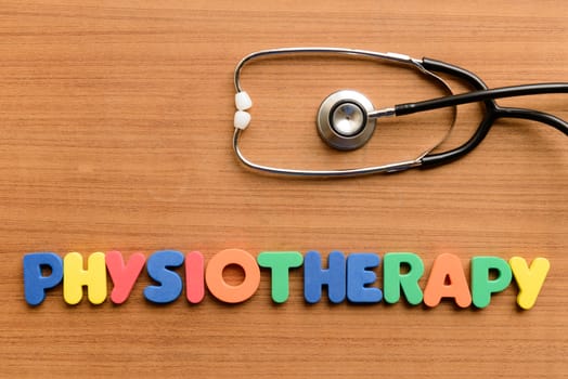 Physiotherapy colorful word on the wooden background