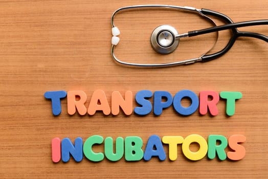 Transport incubators colorful word on the wooden background