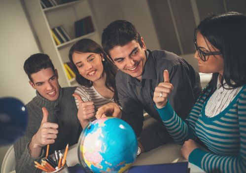 Four beautiful students of Geography learning. They showing thumbs up. Vintage concept.