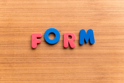 form colorful word on the wooden background