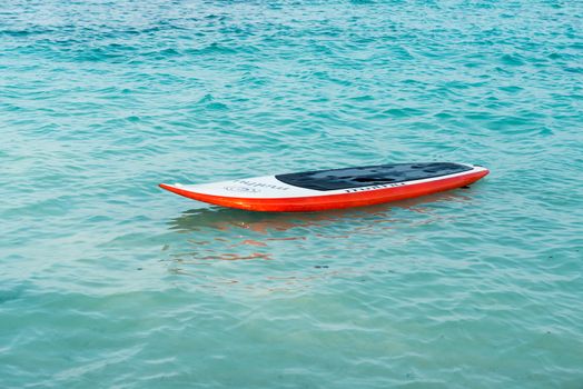 Man paddling on stand up paddle board at indian ocean