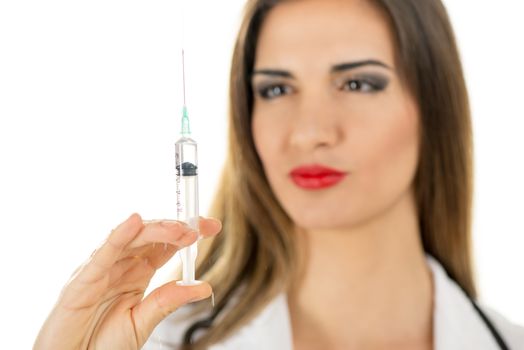 Close-up of a beautiful nurse holding injections. Focus on injections.
