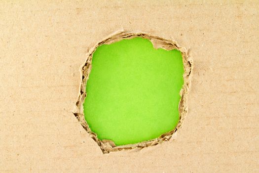 Brown  torn paper over paper green background 
