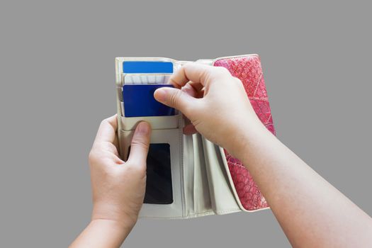 Isolated hands pull credit or debit card out of wallet