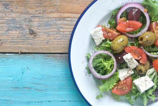 Plate of freshly made salad with tomatoes and feta 