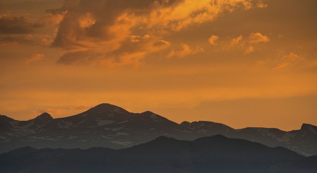 silhouette of Front Range of Rocky Mountains against sunset sky, Longmont, Colorado