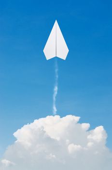 Paper plane flying up, over clouds with blue sky.