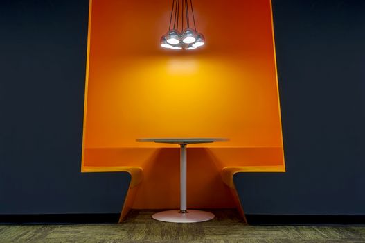 Lobby area of a modern office with orange color wall.