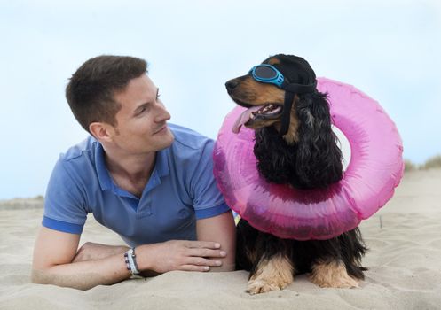 man and cocker spaniel on the beach