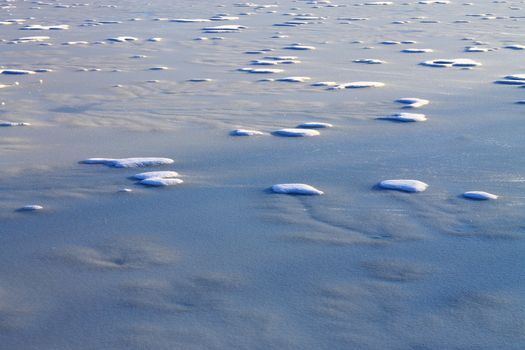 Frozen Pond - Snow and ice patterns on a winter lake.