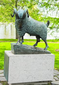 monument of sheep on a background of trees