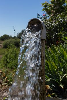 Water flowing from a well pipe