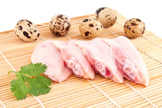 raw chicken wing on a mat , isolated on white background 