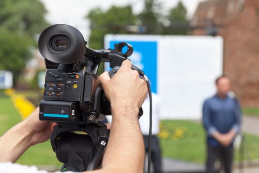 Filming press conference with a video camera