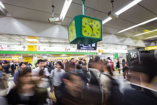 Crowd of people during rush hour on Tokyo metro.