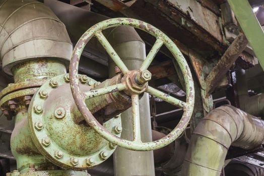 Industrial rusty valve in an abandoned factory
