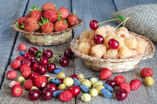 Different berries on the old boards, rustic style