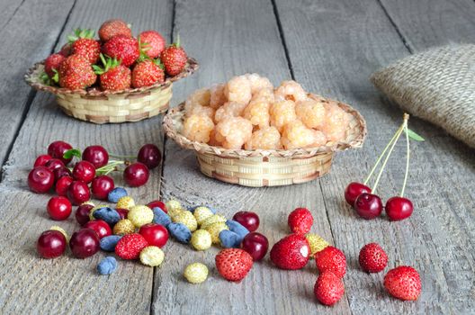 Different berries on the old boards, rustic style