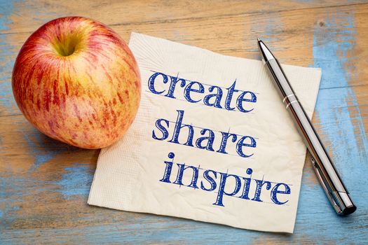 create, share inspire motivational words - handwriting on a napkin with a fresh apple