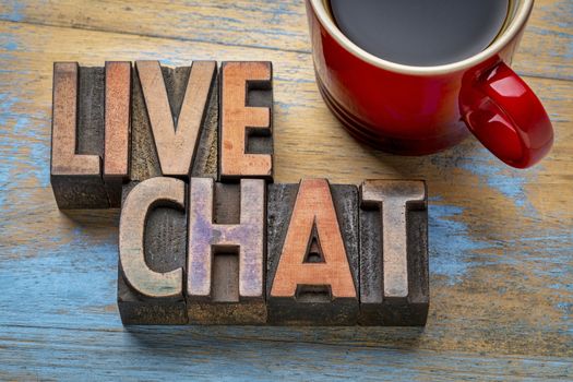 live chat word abstract in vintage letterpress wood type with a cup of coffee