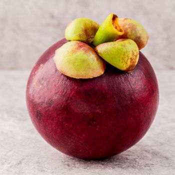 Delicious mangosteen fruit arranged on stone background.Mangosteen the queen of thai fruits.