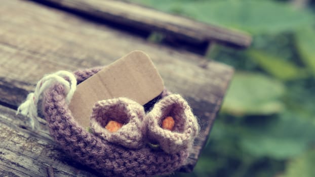 Knitted tulip flower on old wooden background in vintage color, knit is hobby leisure for who like make handmade from yarn