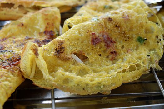 Vietnam food, banh xeo or vietnamese pancake make from rice flour and filled with a shrimp, meat, soya bean sprouts, is popular Viet Nam street food