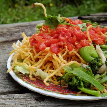 Vietnamese food, vegetarian eating from noodle with vegetable, meal for diet, rich fiber, colorful on plate with tomato, cabbage, mushroom, cauliflower