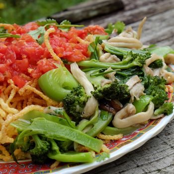 Vietnamese food, vegetarian eating from noodle with vegetable, meal for diet, rich fiber, colorful on plate with tomato, cabbage, mushroom, cauliflower