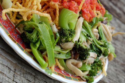 Vietnamese food, vegetarian eating from noodle with vegetable, meal for diet, rich fiber, colorful on plate with tomato, cabbage, mushroom, cauliflower