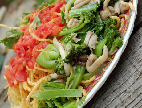 Vietnamese food, vegetarian eating from noodle with vegetable, meal for diet, rich fiber, colorful on plate with tomato, cabbage, mushroom, cauliflower
