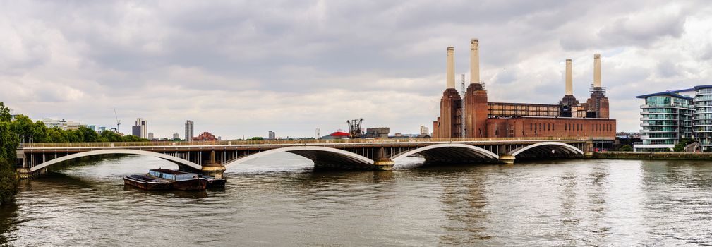 Panoramic view of a rail bridge over the River Thames and Battersea Power Station in London, UK